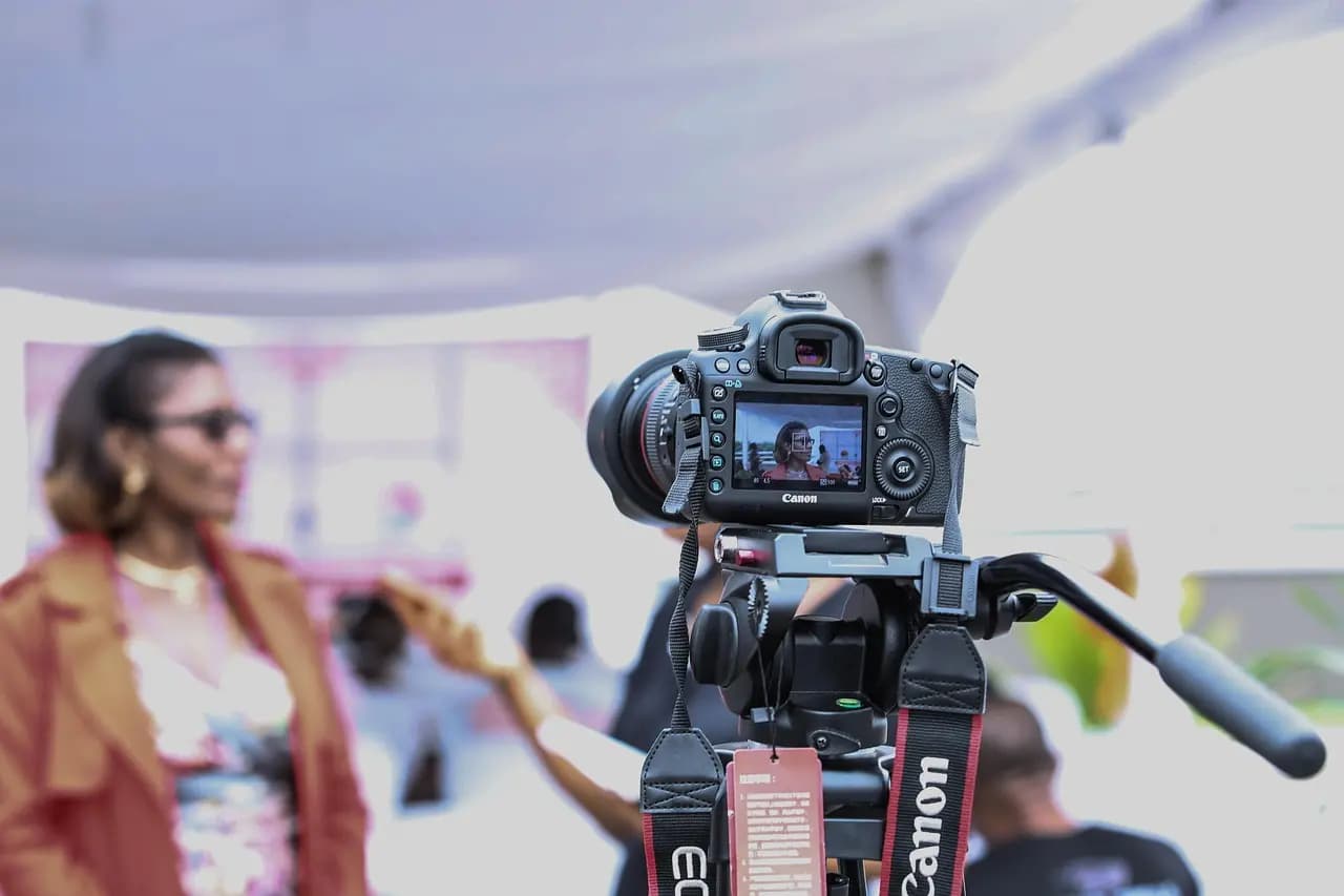 Professional camera on tripod recording a live broadcast, representing 1Social's multi-platform live streaming feature